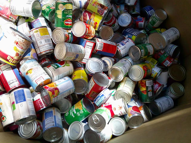 Cans in a cardboard container.